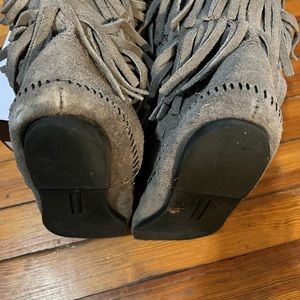 Fringed Minnetonka suede flat boots.